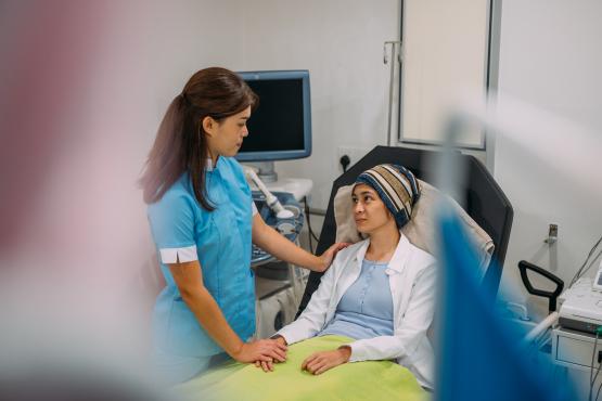 Health worker holding hands of cancer patient in hospital during receiving treatment. Cancer Patient Receiving Treatment and Psychological help concept