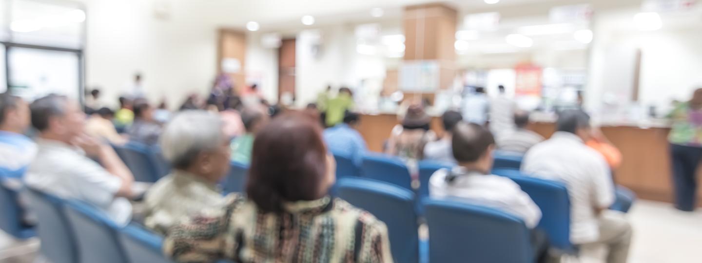 Blur medical background clinic service counter lobby with patient paying bill at cashier desk in hospital